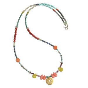 chase the sun colourful necklace with a mix of gemstones in turquoise, coral, lemonite, apatite, lapis lazouli featuring a gold sun charm in the center